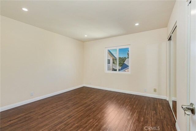 empty room with dark hardwood / wood-style floors