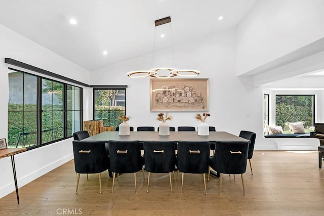 dining area with plenty of natural light, a notable chandelier, and light hardwood / wood-style flooring