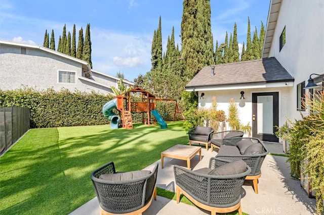 view of yard with an outdoor living space, a patio area, and a playground