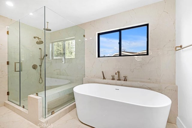 bathroom featuring plus walk in shower and tile walls