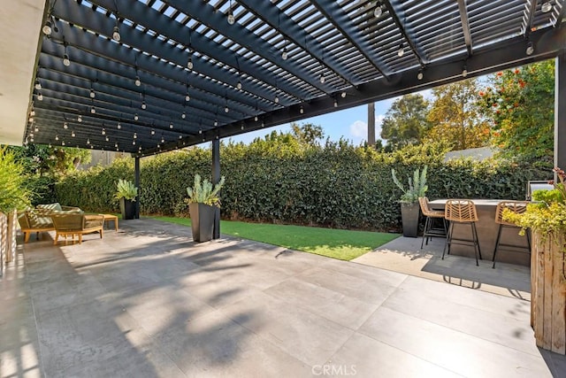 view of patio featuring a pergola and a bar