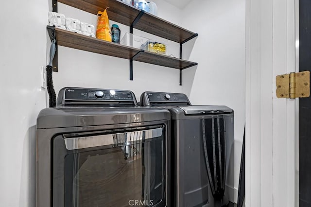 clothes washing area featuring independent washer and dryer