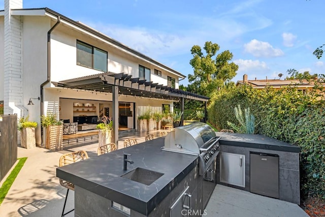 view of patio featuring a pergola, area for grilling, sink, and exterior kitchen