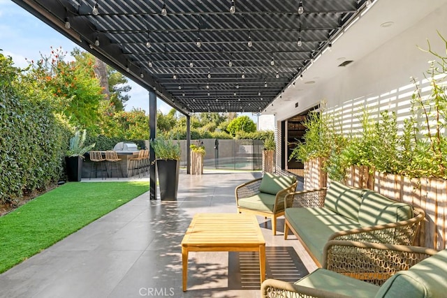 view of patio / terrace with outdoor lounge area, an outdoor bar, and exterior kitchen