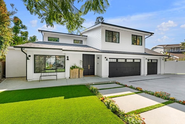 view of front of home featuring a garage and a front yard