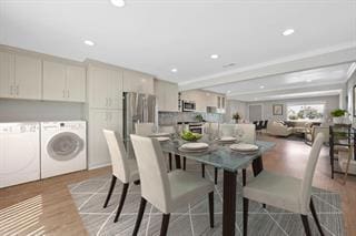 dining room with washer and clothes dryer and light hardwood / wood-style flooring