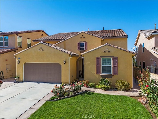 mediterranean / spanish-style house featuring a front yard and a garage