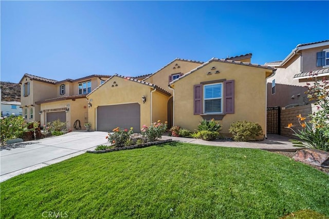 mediterranean / spanish home featuring a front yard and a garage