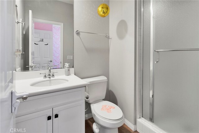 bathroom featuring vanity, toilet, and walk in shower