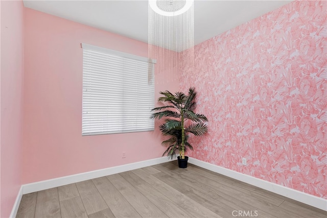 spare room with wood-type flooring