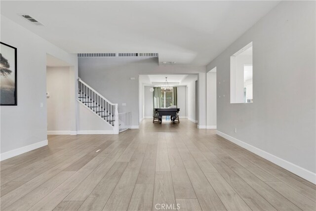 interior space with light hardwood / wood-style floors, a chandelier, and pool table