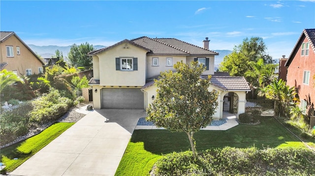 mediterranean / spanish house with a garage and a front lawn