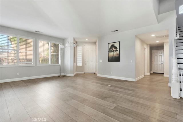 unfurnished living room with light wood-type flooring