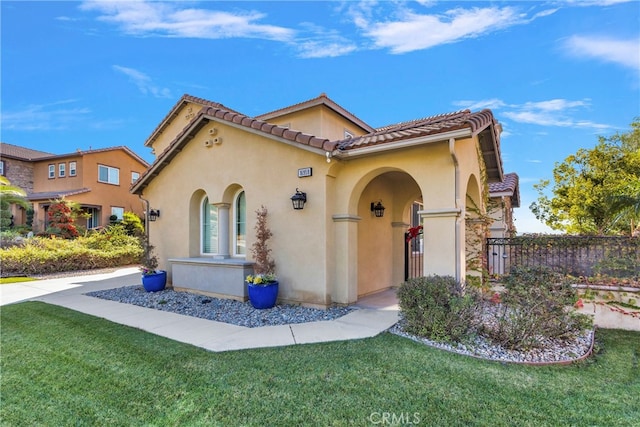 mediterranean / spanish-style home with a front lawn