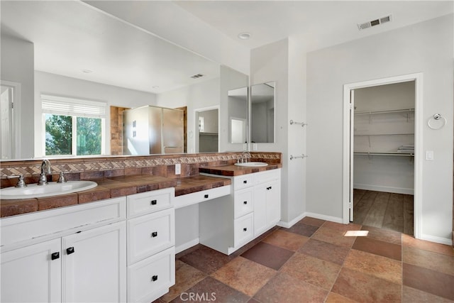 bathroom with vanity and an enclosed shower