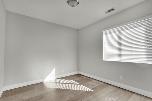 unfurnished room with light wood-type flooring