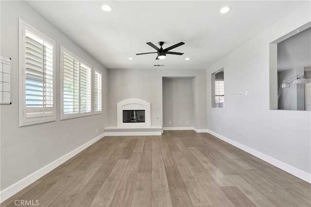 unfurnished living room featuring light hardwood / wood-style floors and ceiling fan