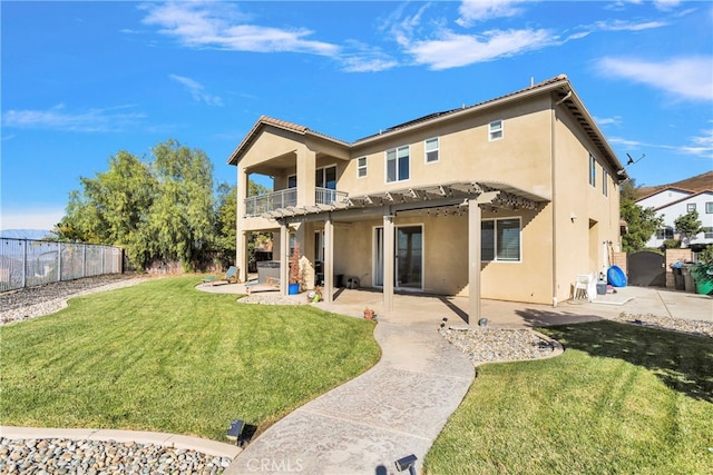 rear view of house featuring a patio area, a yard, a balcony, and a pergola