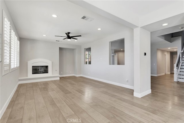 unfurnished living room with light hardwood / wood-style flooring and ceiling fan