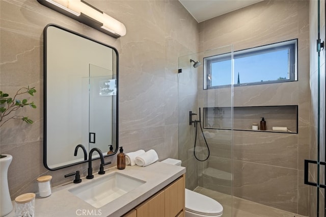 bathroom with vanity, toilet, and an enclosed shower