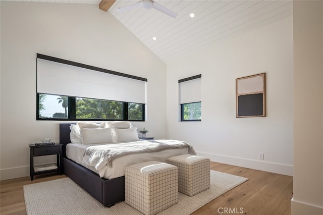 bedroom with light hardwood / wood-style floors, ceiling fan, beamed ceiling, wooden ceiling, and high vaulted ceiling