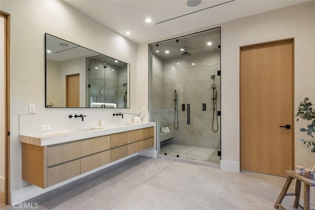 bathroom with vanity and a shower with door