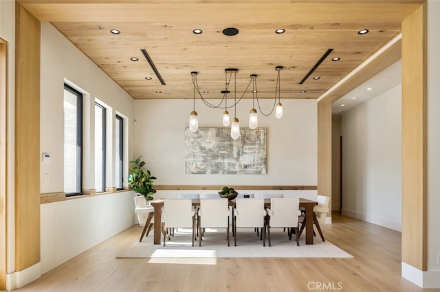 unfurnished dining area with light hardwood / wood-style floors and wood ceiling