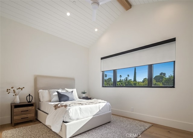 bedroom with ceiling fan, hardwood / wood-style flooring, high vaulted ceiling, and beam ceiling