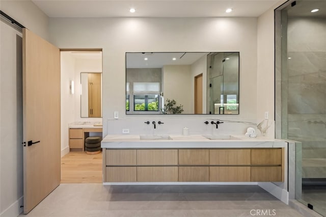 bathroom featuring vanity, an enclosed shower, and hardwood / wood-style floors