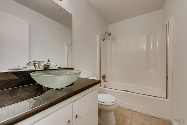 full bathroom featuring toilet, tile patterned flooring, vanity, and tub / shower combination