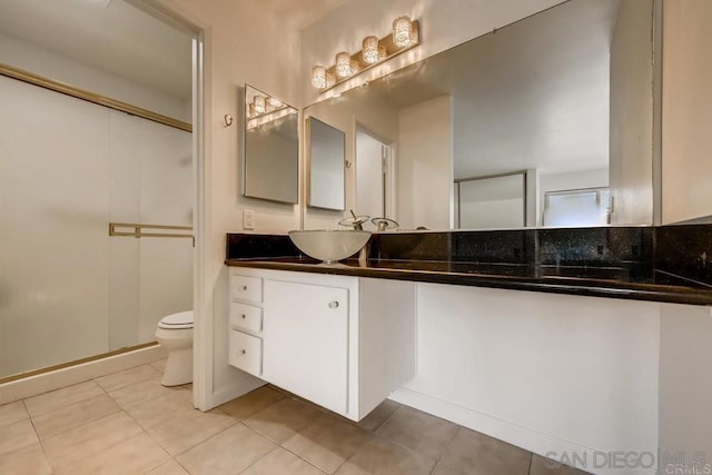 bathroom with tile patterned floors, vanity, and toilet