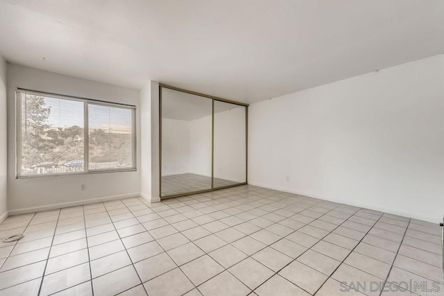 unfurnished bedroom featuring a closet and light tile patterned flooring