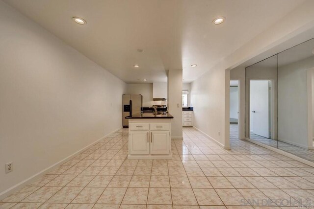 kitchen with stainless steel refrigerator with ice dispenser and light tile patterned floors