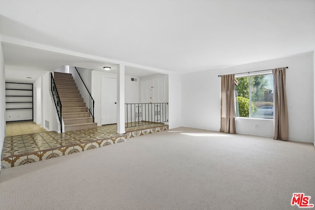 unfurnished room with light carpet