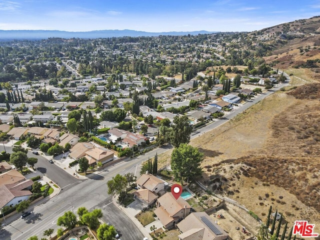 birds eye view of property with a mountain view