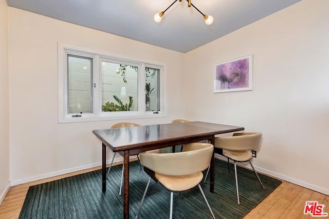 dining room featuring wood-type flooring and a notable chandelier