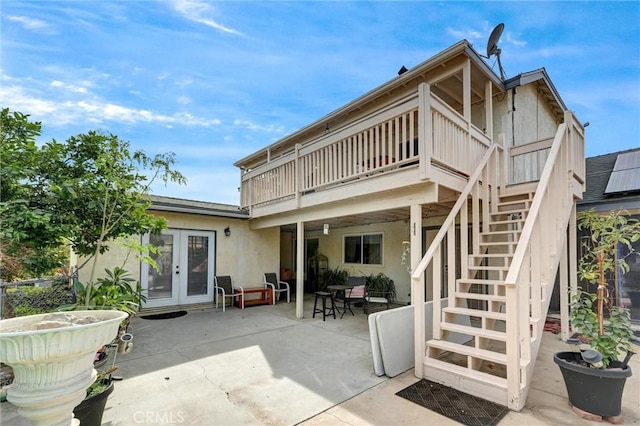 back of property featuring a patio, french doors, and a balcony