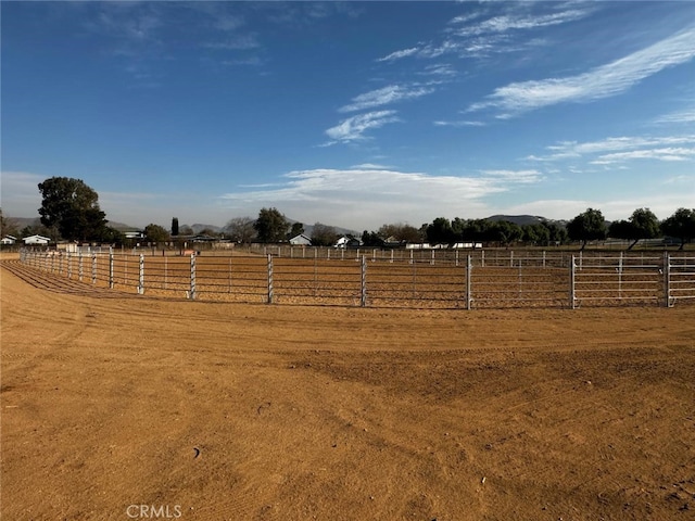 view of yard with a rural view