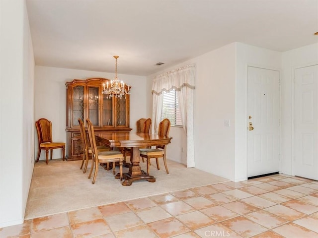 tiled dining room with a notable chandelier