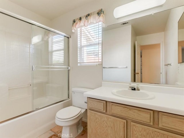 full bathroom featuring tile patterned flooring, vanity, enclosed tub / shower combo, and toilet