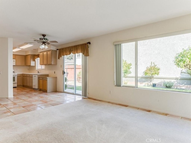 kitchen featuring ceiling fan, white appliances, and light carpet