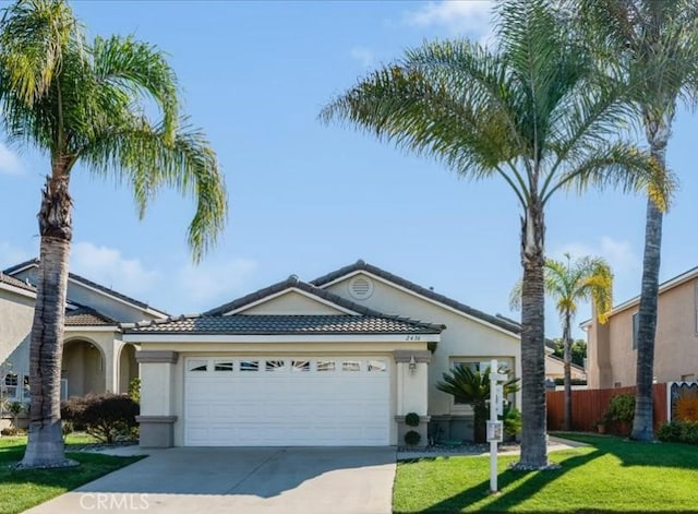 single story home with a garage and a front lawn