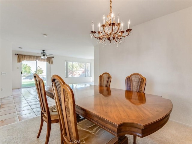 tiled dining area featuring ceiling fan with notable chandelier