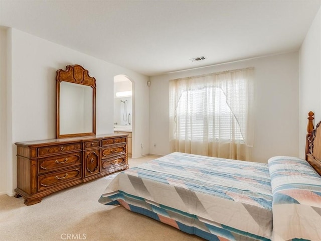 carpeted bedroom featuring ensuite bathroom