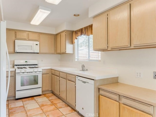 kitchen with light brown cabinets, light tile patterned flooring, white appliances, and sink