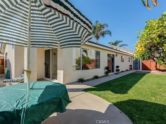 rear view of house featuring a lawn