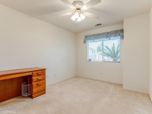 unfurnished room featuring light carpet and ceiling fan