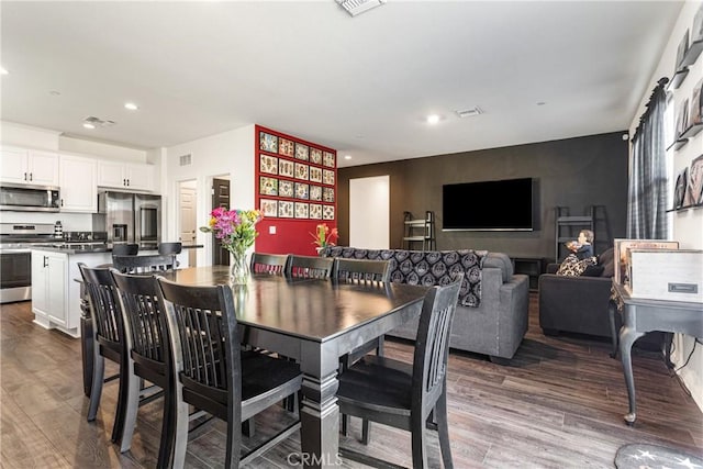 dining space with wood-type flooring