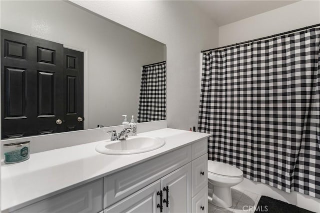 bathroom featuring tile patterned floors, vanity, and toilet