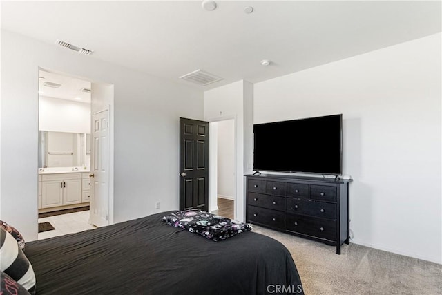 carpeted bedroom featuring ensuite bathroom